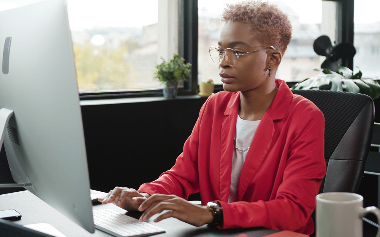 Woman working on computer at desk